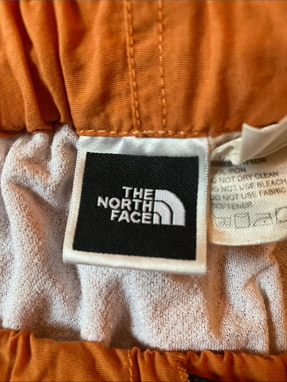 The North Face Men's Orange Athletic Shorts with Buckle Waist